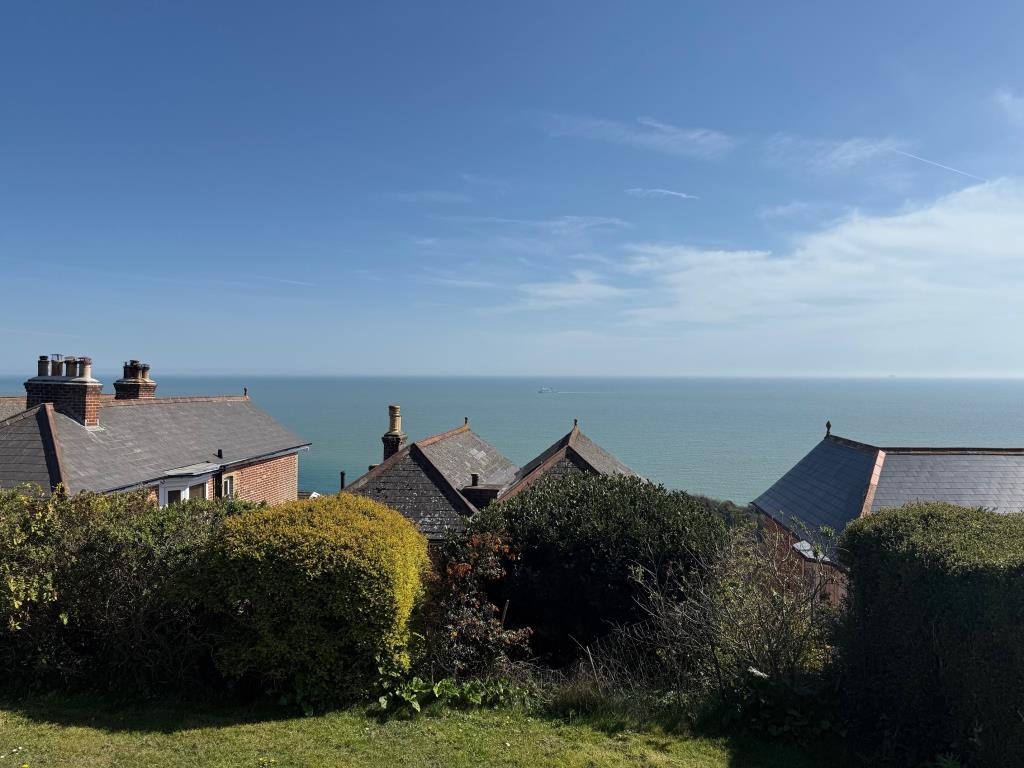 Lot: 163 - FOUR-BEDROOM HOUSE FOR IMPROVEMENT WITH STUNNING SEA VIEWS AND REAR VEHICULAR ACCESS - A View from the rear of the back garden
